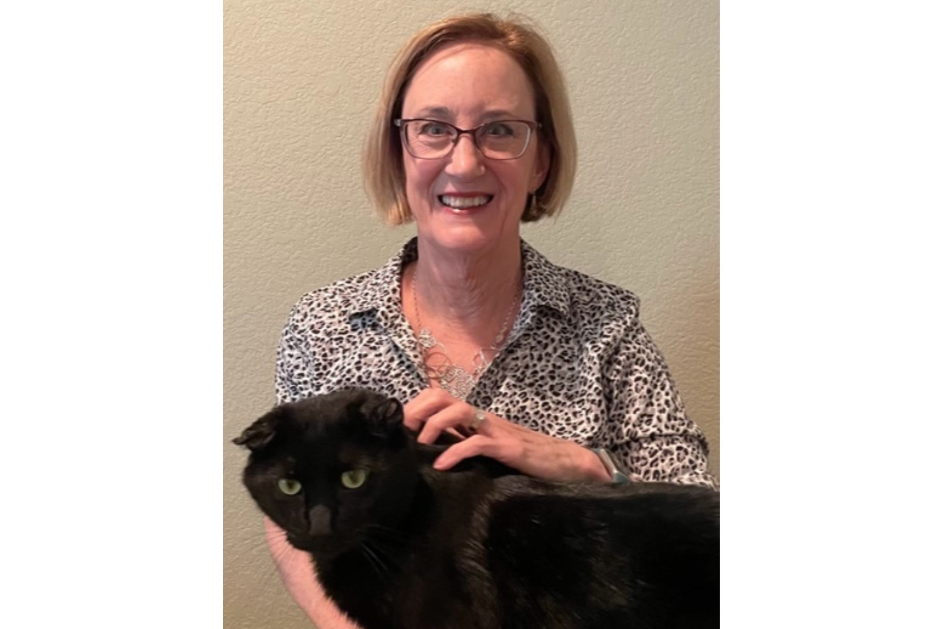 a black cat and a woman are pictured together
